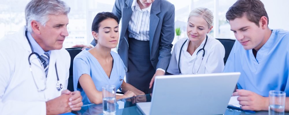 Team of doctors and businesswoman having a meeting in medical office